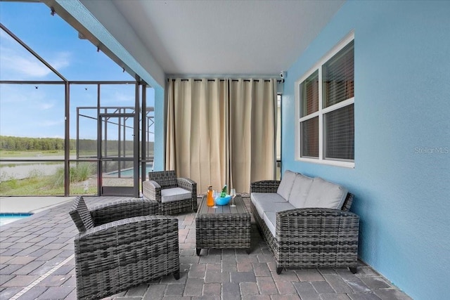 view of patio / terrace with an outdoor pool, glass enclosure, and an outdoor hangout area