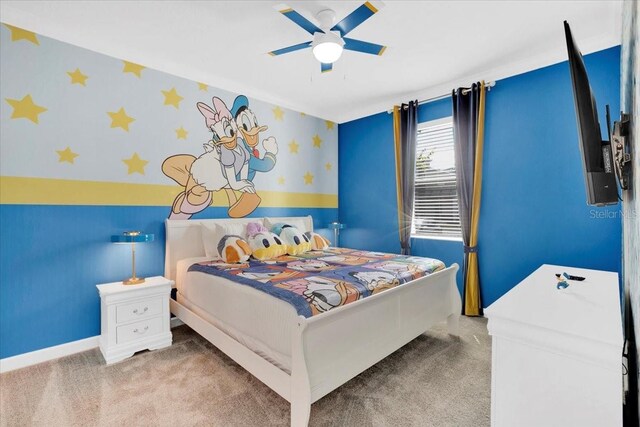 bedroom featuring ceiling fan and light carpet