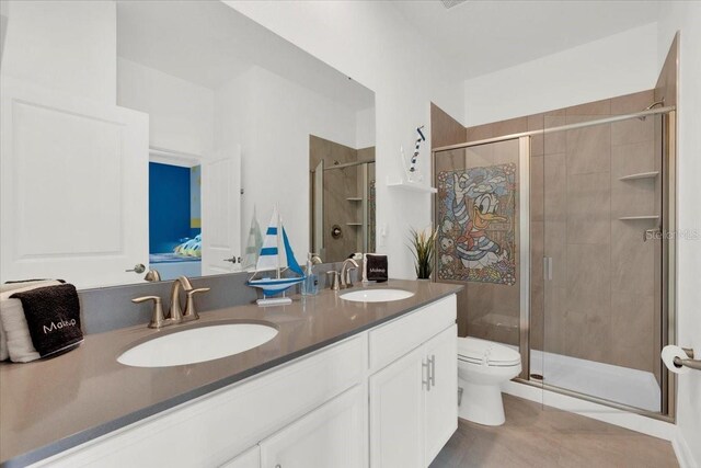 bathroom with double vanity, toilet, an enclosed shower, and tile patterned floors