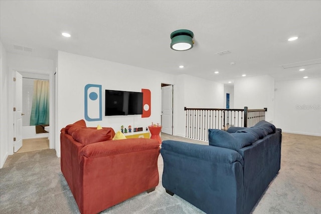 living area with recessed lighting, visible vents, and light colored carpet