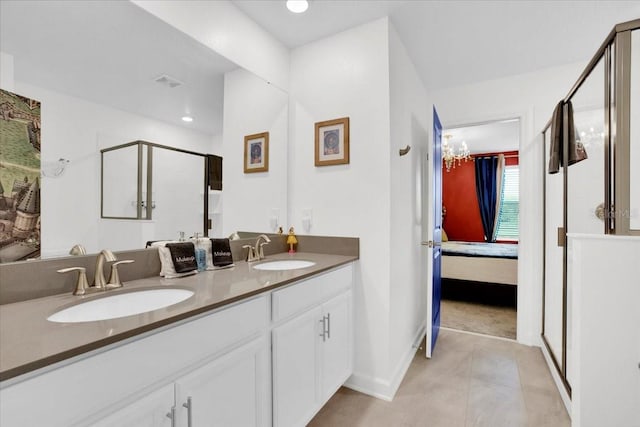 bathroom with walk in shower, double vanity, and tile patterned flooring