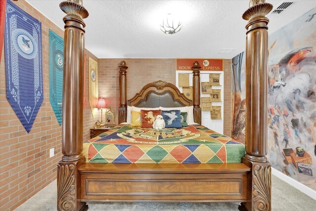 bedroom featuring a textured ceiling, brick wall, and carpet