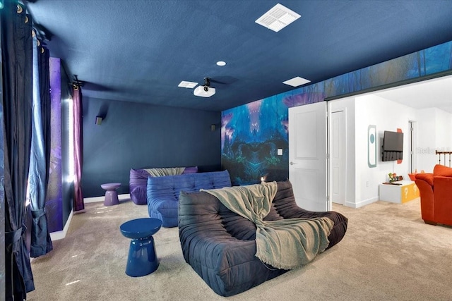 carpeted home theater featuring baseboards, visible vents, and a textured ceiling