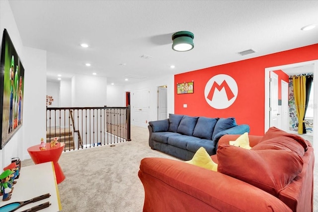 carpeted living area featuring visible vents and recessed lighting
