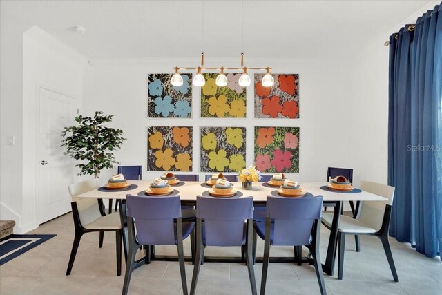 tiled dining space featuring ornamental molding