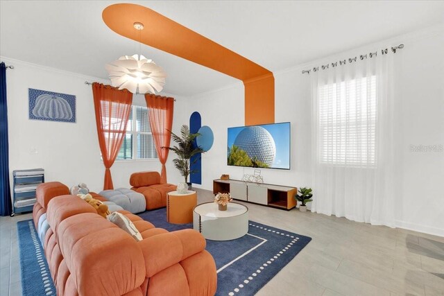 living room with tile patterned floors and crown molding