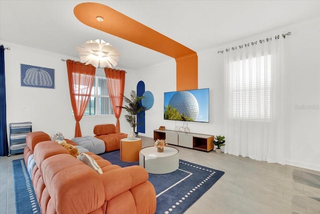 living area featuring a healthy amount of sunlight and ornamental molding