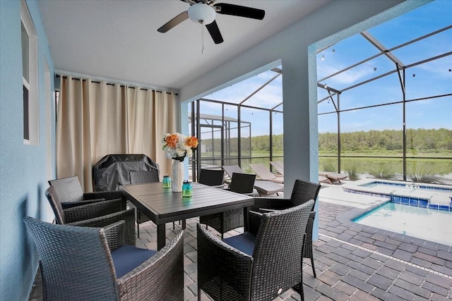 sunroom featuring a swimming pool and ceiling fan