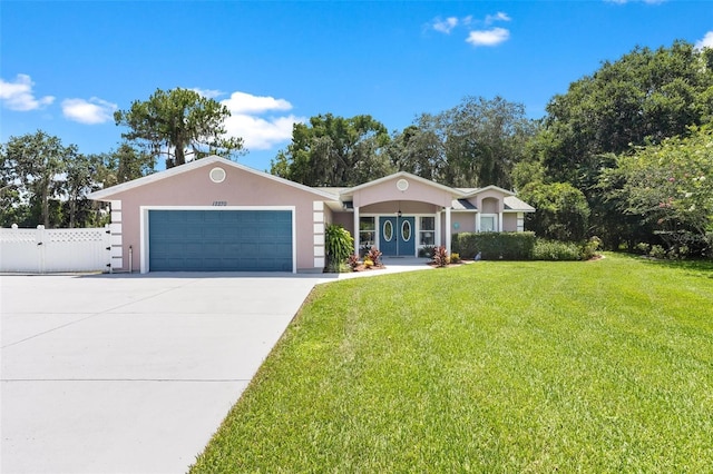 ranch-style house featuring a front lawn and a garage