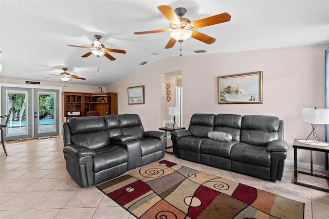 tiled living room featuring ceiling fan, french doors, and lofted ceiling