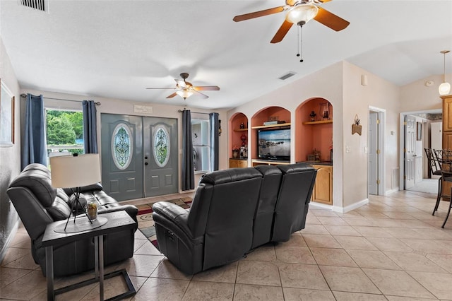 living room featuring built in features, ceiling fan, a textured ceiling, and light tile flooring