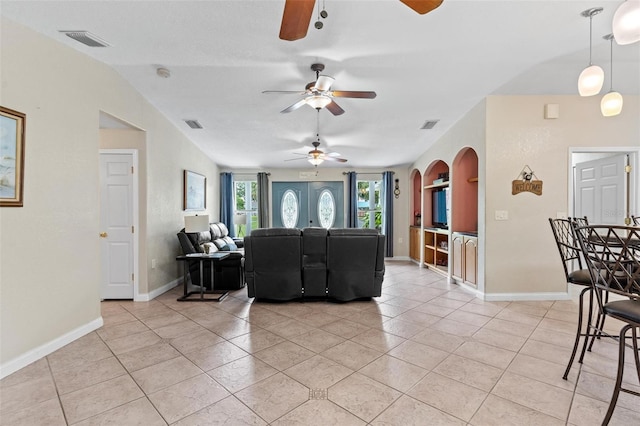 tiled living room with ceiling fan and lofted ceiling