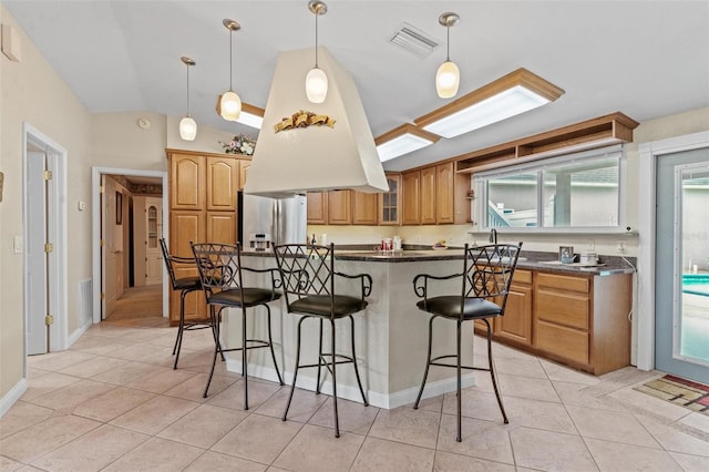 kitchen featuring a wealth of natural light, light tile flooring, and stainless steel fridge with ice dispenser