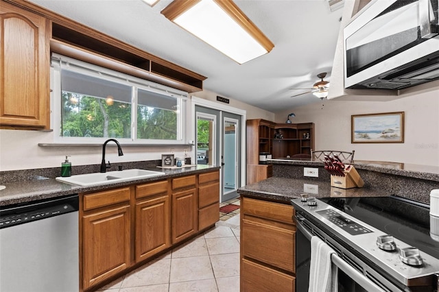 kitchen featuring appliances with stainless steel finishes, sink, ceiling fan, and a wealth of natural light