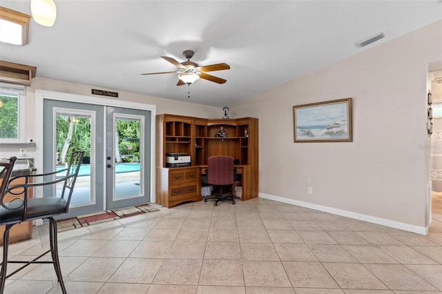 tiled office space featuring vaulted ceiling, ceiling fan, and french doors