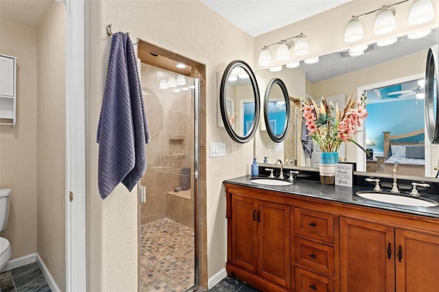 bathroom featuring double sink, an enclosed shower, tile floors, toilet, and large vanity