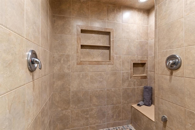 bathroom with a tile shower