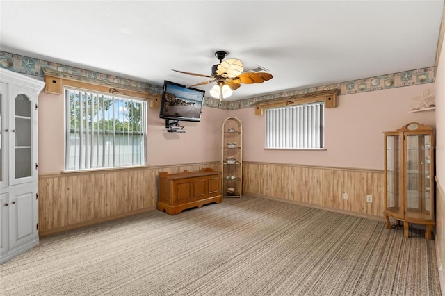 empty room with ceiling fan and light colored carpet