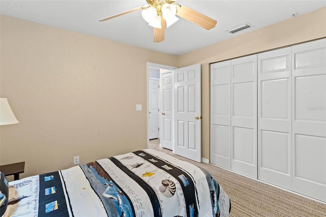 carpeted bedroom featuring a closet and ceiling fan