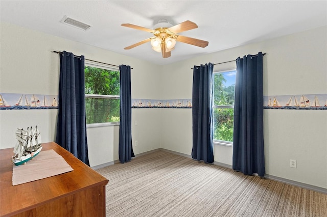 unfurnished office featuring ceiling fan and light carpet