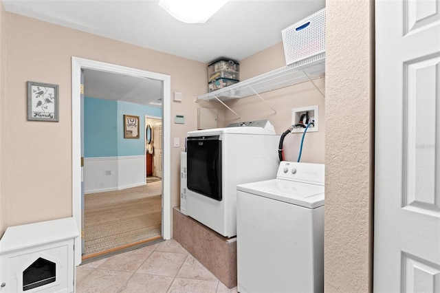 washroom with hookup for a washing machine, washing machine and clothes dryer, and light tile floors