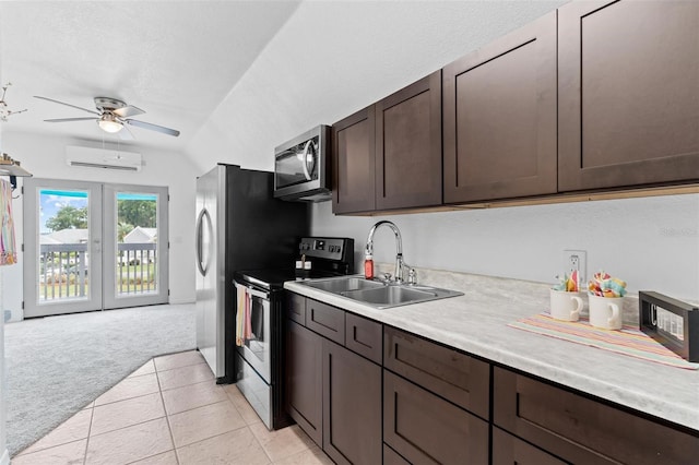 kitchen with stainless steel appliances, light carpet, dark brown cabinetry, sink, and ceiling fan