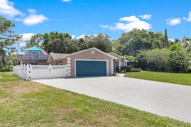 single story home featuring a garage and a front yard