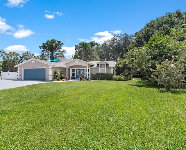 ranch-style house with a garage and a front yard