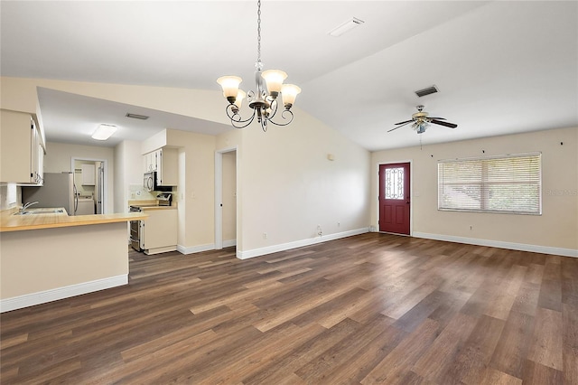 unfurnished living room with ceiling fan with notable chandelier, vaulted ceiling, dark wood-type flooring, and sink