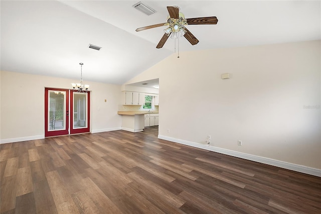 unfurnished living room featuring lofted ceiling, ceiling fan with notable chandelier, and dark hardwood / wood-style floors