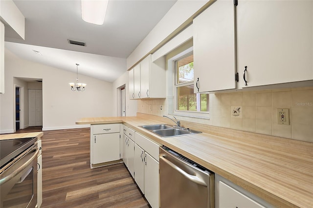 kitchen with white cabinetry, sink, stainless steel dishwasher, pendant lighting, and lofted ceiling