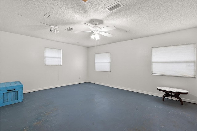 spare room featuring ceiling fan and a textured ceiling