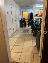 hallway with tile patterned floors