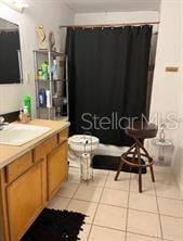 bathroom with tile patterned flooring, vanity, and toilet