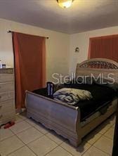 bedroom with light tile patterned floors