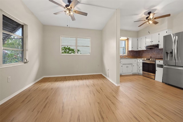 kitchen with light hardwood / wood-style flooring, decorative backsplash, ceiling fan, white cabinetry, and stainless steel appliances