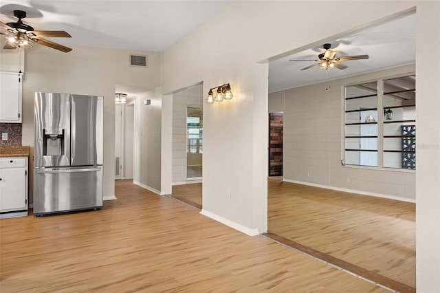 kitchen with light hardwood / wood-style floors, ceiling fan, white cabinetry, and stainless steel fridge with ice dispenser