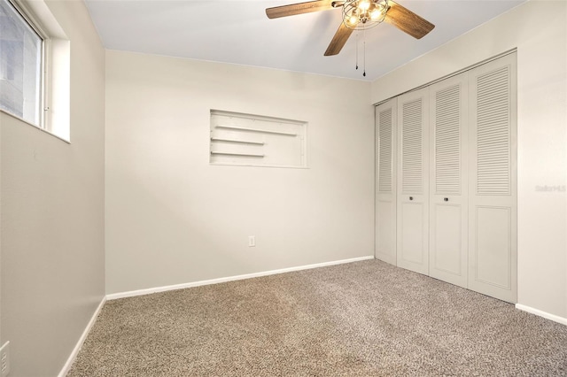 unfurnished bedroom with carpet, a closet, and ceiling fan