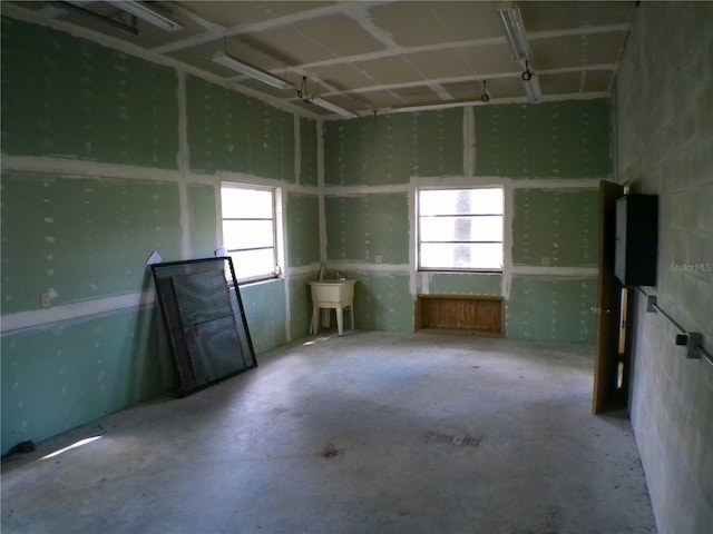 interior space with sink, concrete flooring, and a wealth of natural light