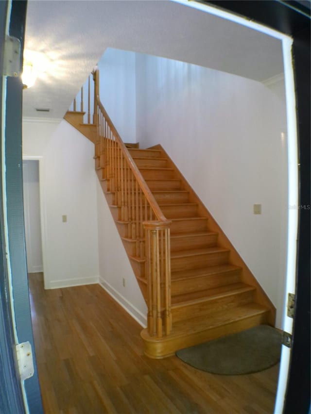 stairs with hardwood / wood-style floors