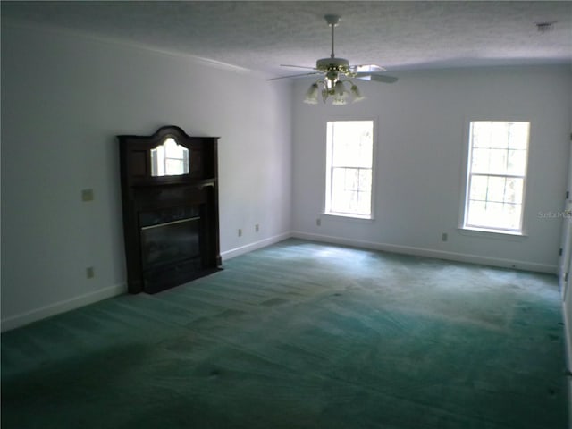 unfurnished living room featuring plenty of natural light, dark colored carpet, and a textured ceiling