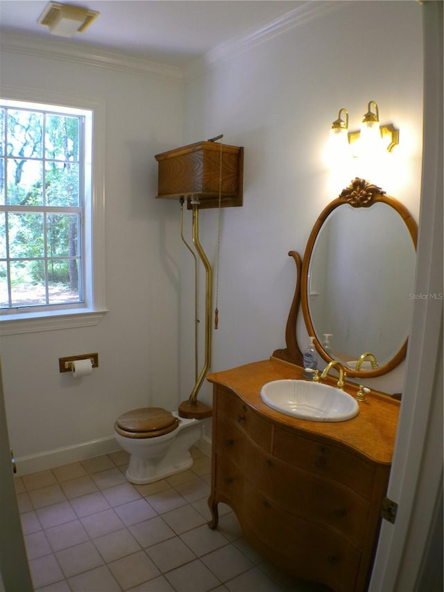 bathroom with ornamental molding, vanity, toilet, and tile patterned floors