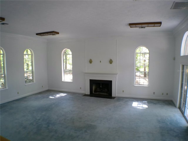 unfurnished living room with crown molding and carpet floors