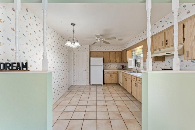 kitchen with ceiling fan with notable chandelier, white appliances, sink, hanging light fixtures, and light tile patterned flooring