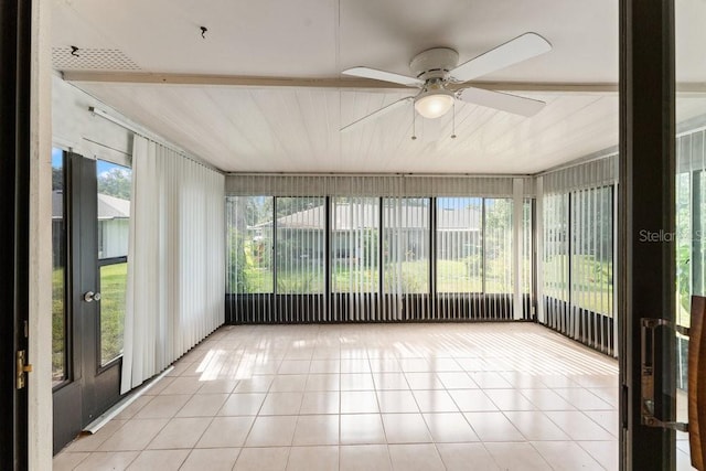 unfurnished sunroom with ceiling fan and a healthy amount of sunlight