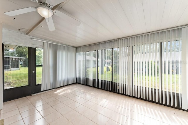 unfurnished sunroom featuring ceiling fan