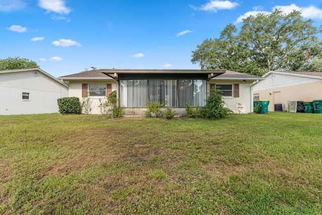 rear view of property with a lawn