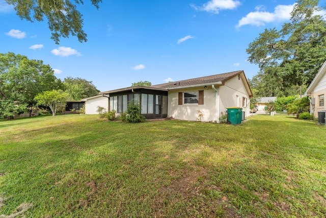 rear view of property with a yard and cooling unit