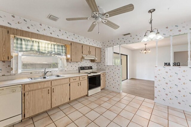 kitchen featuring sink, decorative light fixtures, white appliances, and light tile patterned floors