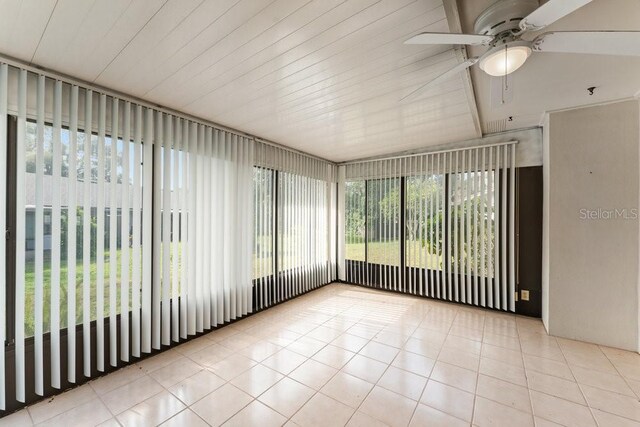 unfurnished sunroom with ceiling fan and plenty of natural light